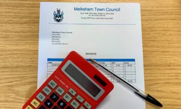 image of an invoice, pen and calculator