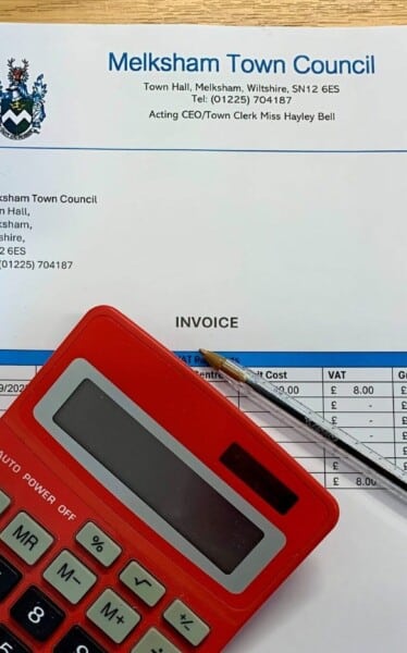 image of an invoice, pen and calculator