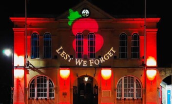 Town Hall with remembrance day projection of poppies projected on the front and pavement.