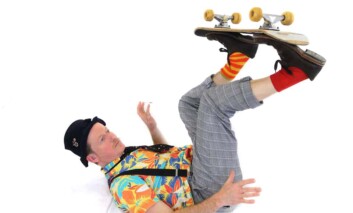 Mr Bert balancing a skateboard on his feet