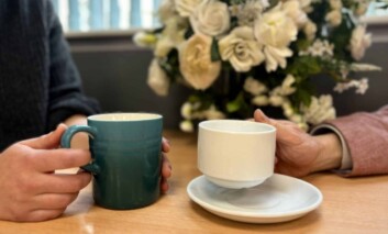 International Friendship Day. Holding coffee cups.