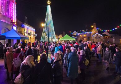 Carol singing in Melksham Market Place around the Christmas tree