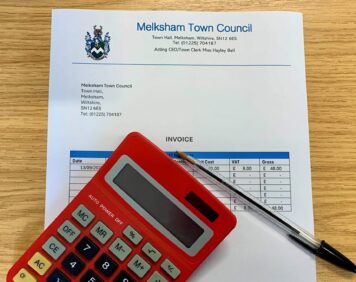 image of an invoice, pen and calculator